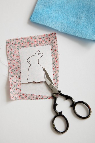Cutting out an Easter bunny motif for a hand-crafted egg cosy