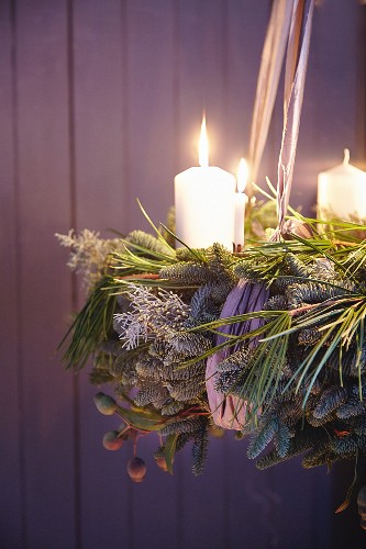 And Advent wreath made from green twigs and pine with white pillar candles