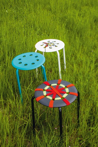 Stools decorated with strips of fabric and wool