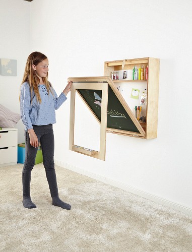 Girl folding down fold-away desk with chalkboard on back