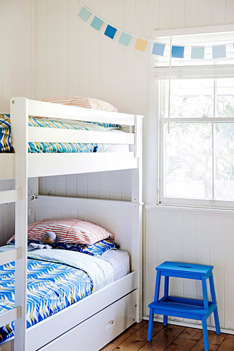bunk bed in front of window