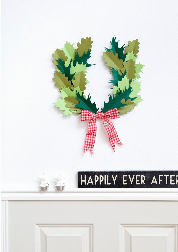 Hand-made wreath of paper leaves with red and white gingham ribbon