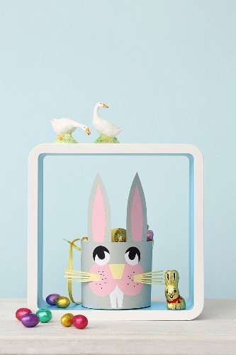 Paper Easter basket with bunny face in shelving module