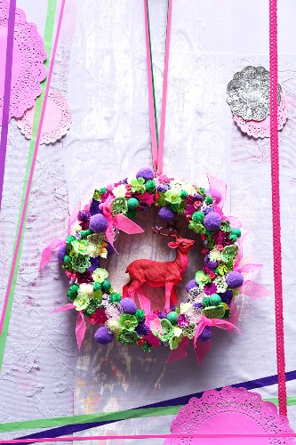 Hand-made door wreath with stag figurine and pink ribbon