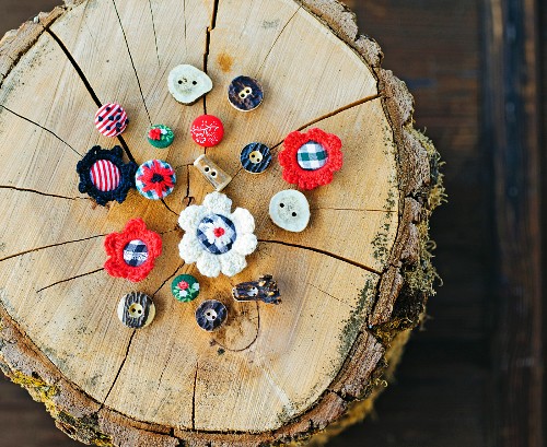 Hand-made buttons for traditional clothing on tree stump