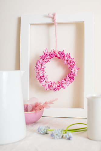 Small wreath of pink hyacinths florets in picture frame