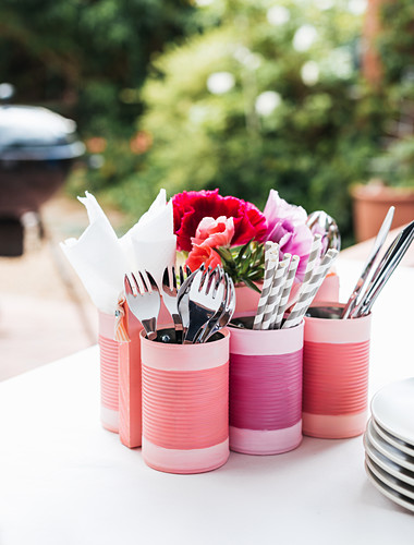 Cutlery holders made from tin cans painted pink