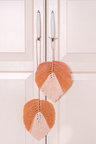 Macramé feathers hanging from the handles of cupboard doors