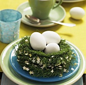 Easter nest with three white eggs