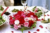 Bowl of roses on table laid for special occasion