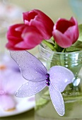 Tulips in glass, tulle butterfly in front
