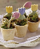 Flowerpots with pastry flowers as table decoration