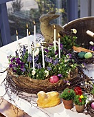 Easter wreath with candles, various Easter decorations on table