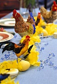 Chickens, cockerels and yellow feathers as Easter decoration