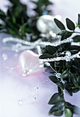 Heart-shaped tree ornament with sprigs of greenery