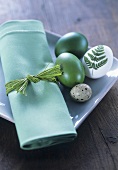 Plate with green fabric napkin and Easter eggs