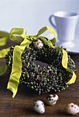Easter wreath with green bow and quail's egg