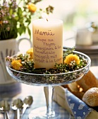 White candle as menu on lavender flowers in glass