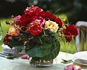 Rustic bouquet of roses on laid table