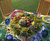 Laid table with vegetables and flower wreath