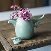 A pink peony in a turquoise jug