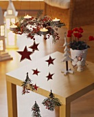 Christmas mobile of tea lights, fir, rose hips, stars