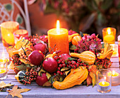 Wreath of pumpkins, apples, rosehips, hydrangeas, autumn leaves