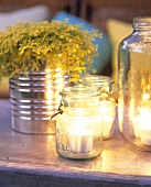 Tea lights in preserving jars; twigs in tin
