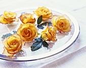 Yellow roses on glass plate