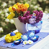 Flower and candle decoration for Easter table in open air