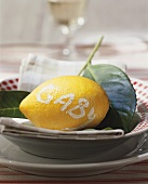 Lemon with the word 'Gaby' on plate