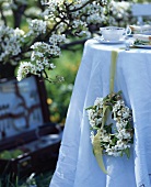 Spring table decoration: wreath of pear blossom (outdoors)
