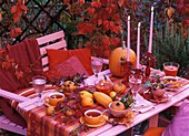 Tea table with autumn decorations in the open air