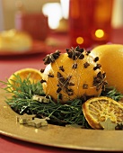 Orange studded with cloves, star anise tied on with thread