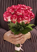 Hands holding bouquet of roses