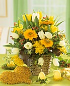 Easter arrangement of marigolds, mimosa and tulips