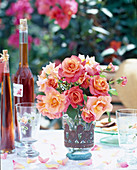 Vase of roses on a garden table