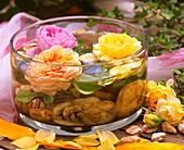 Perfumed roses in a bowl of water