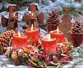 Advent wreath with pink pepper in snow