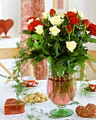Red and white roses in glass vase