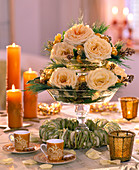 Tiered glass stand decorated with roses for Christmas