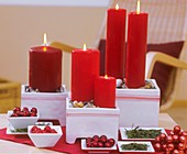 Candles in ceramic pots, stones, baubles and fir needles