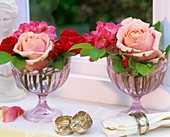 Roses and rhododendrons in glass goblets