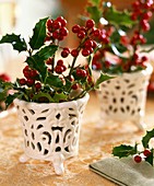 Sprigs of holly in small vases