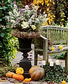 Autumn arrangement in iron amphora with willow wreath
