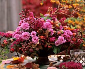 Arrangement of chrysanthemums and rose hips