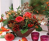 Bowl of roses, rose hips, ornamental peppers