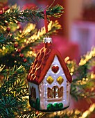 'House' tree ornament on a spruce Christmas tree