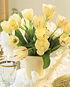 Vase of tulips with goose feathers