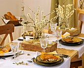 Table decoration of flowering sloe branches and bricks 
